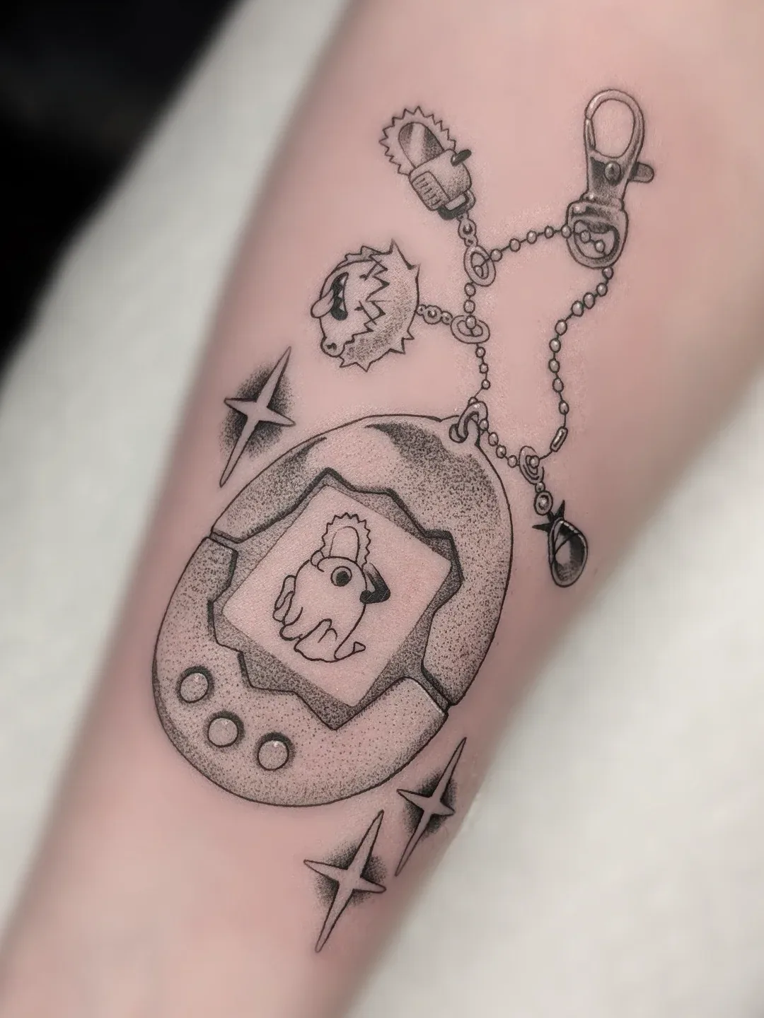 Black grey tamagotchi keychain forearm tattoo raleigh