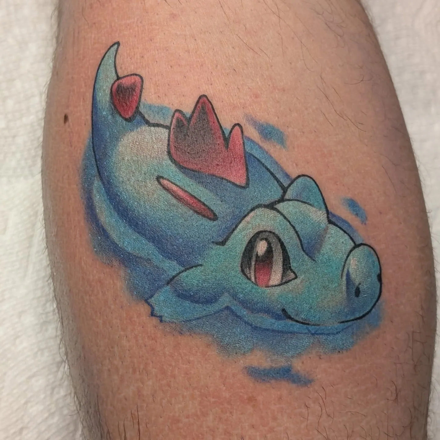 Blue dragon creature calf tattoo raleigh