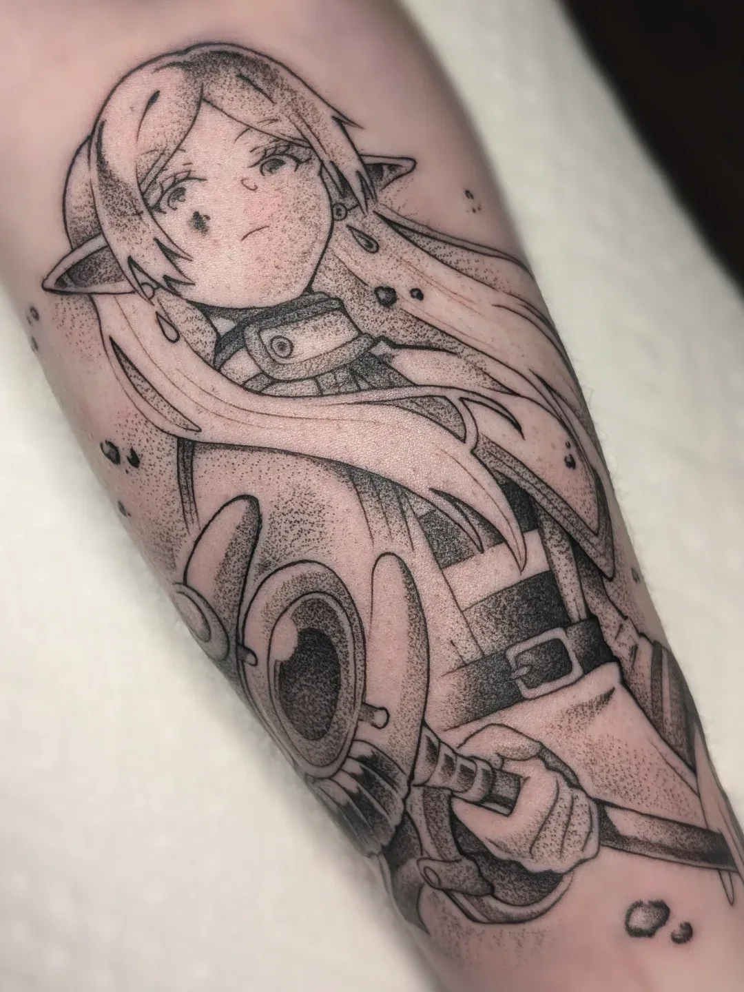 Elf girl blindfold forearm tattoo raleigh