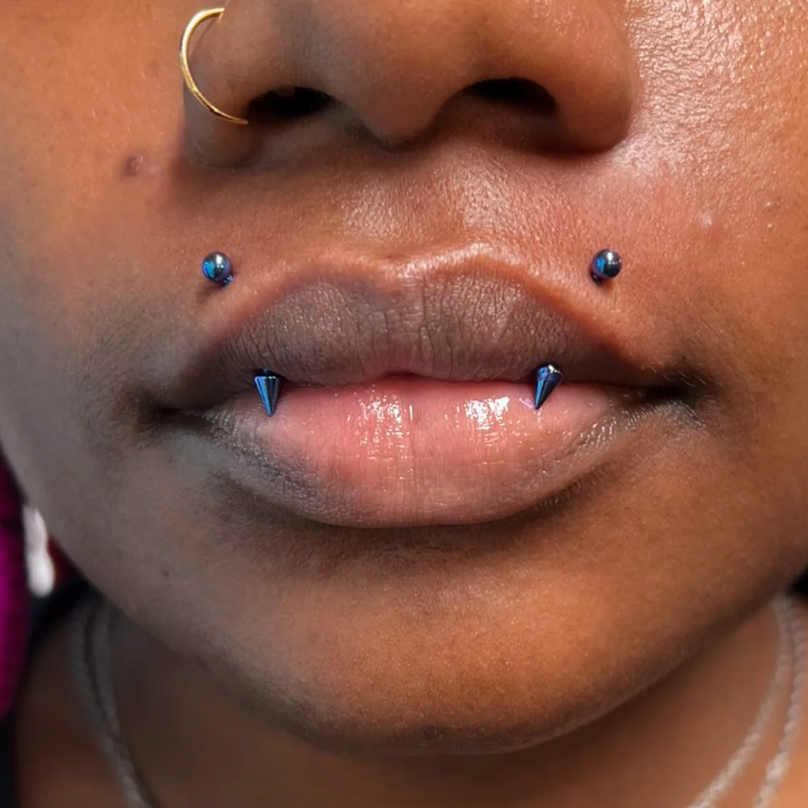 Double canine lip piercing spike jewelry raleigh