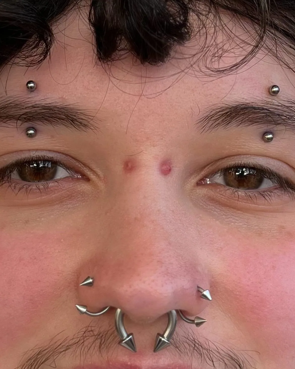 Double eyebrow and nostril piercings spikes raleigh